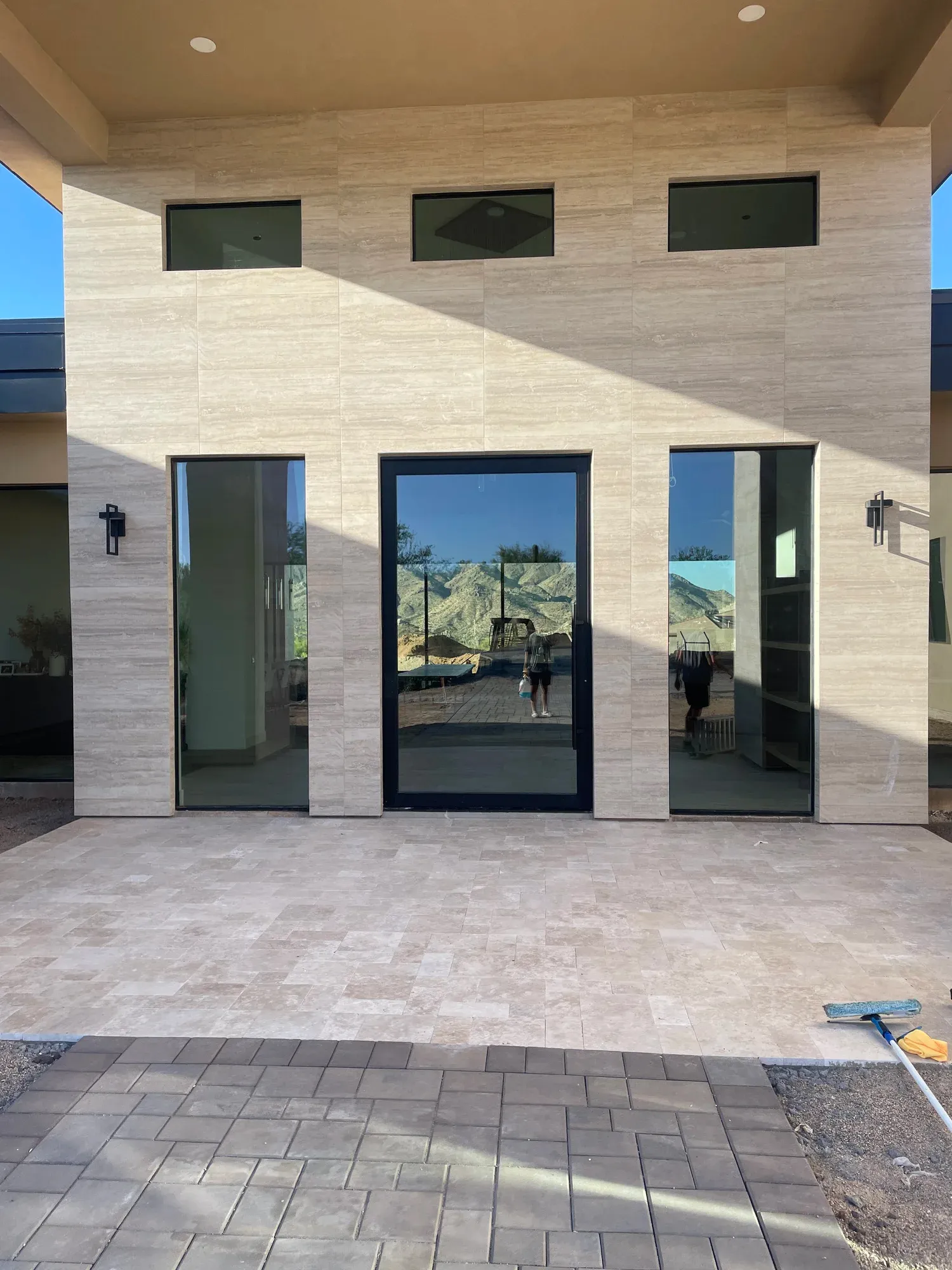 Dark-framed exterior windows and glass doors on a modern home
