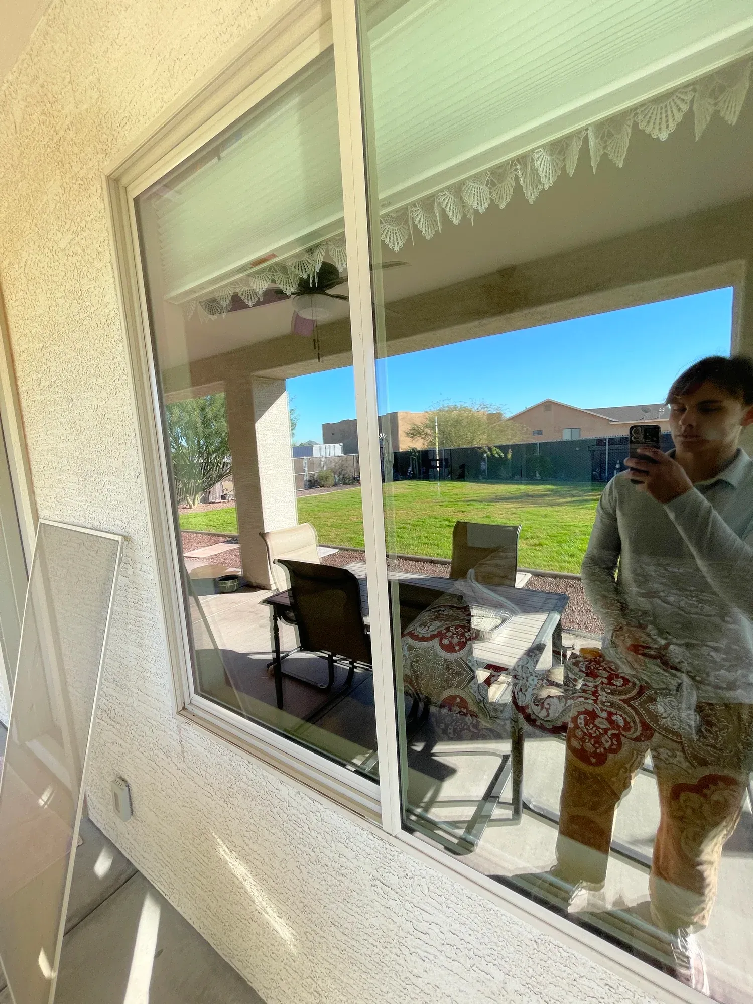 Clean patio windows reflecting the backyard
